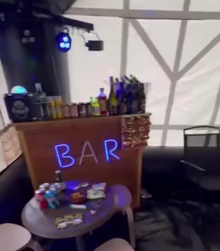 Inflatable pub interior — the bar with BAR neon sign, bottles and disco lights