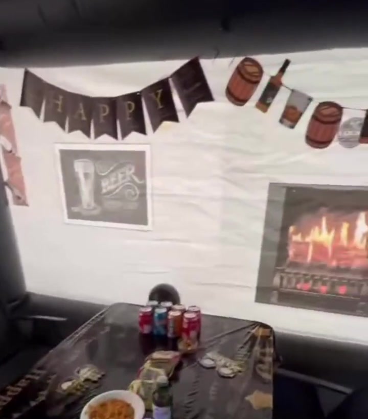 Inflatable pub interior — HAPPY banner, fireplace, table with drinks